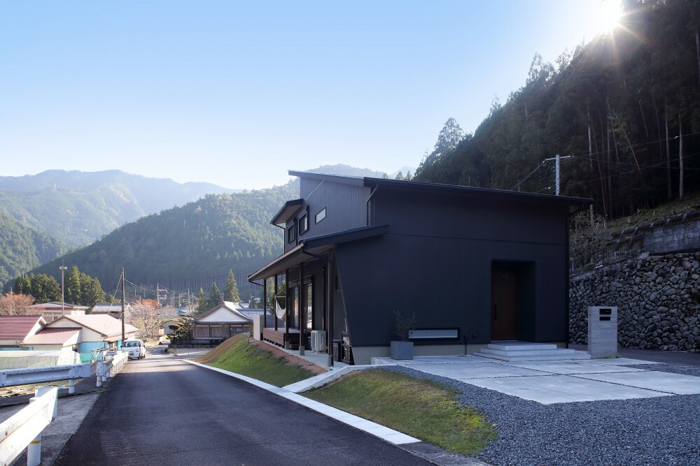 黒い和モダンの家は玄関前にオープンスペースを設けて外構計画で土間部分に駐車場を計画した事例