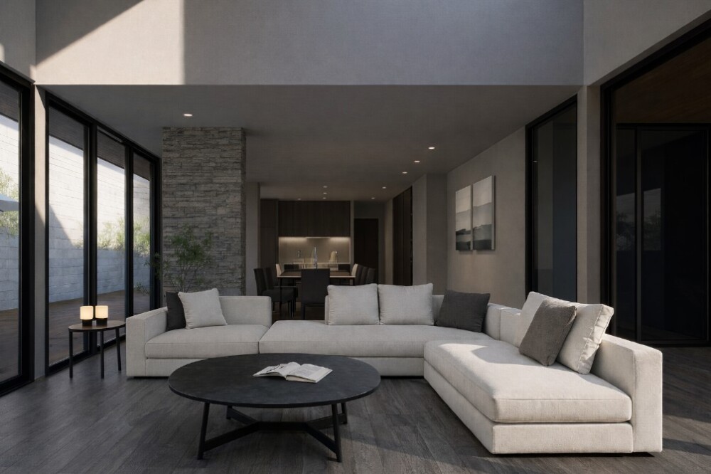 グレー色のフローリングで統一したモダンなリビング・ダイニング空間。明るいベージュのL字ソファとブラックのテーブルが調和し、ガラスの大開口と石調の壁がホテルライクで洗練された印象を与える。インテリア初心者でも取り入れやすい床色の実例。