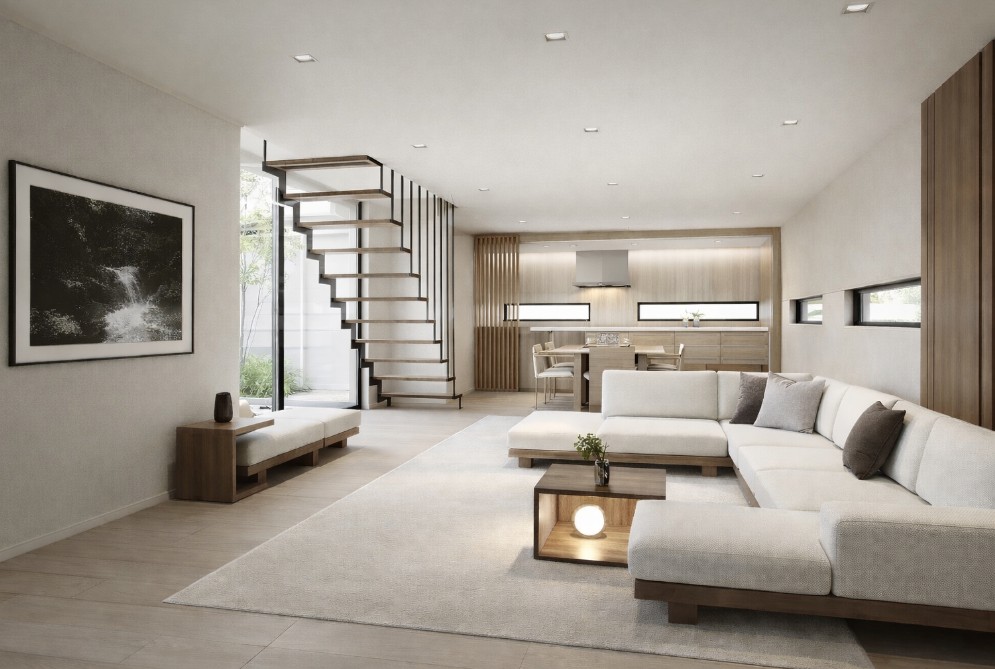 ダイニングテーブルの奥にI型キッチンを配置したホテルライクなシンプルモダンのLDK空間。視線と動線を整理することで認知的負荷を抑え、判断疲れを軽減する設計。無垢材フローリングと淡いトーンの家具、フローティング階段が静かな秩序と所作の流れを生む住まい。